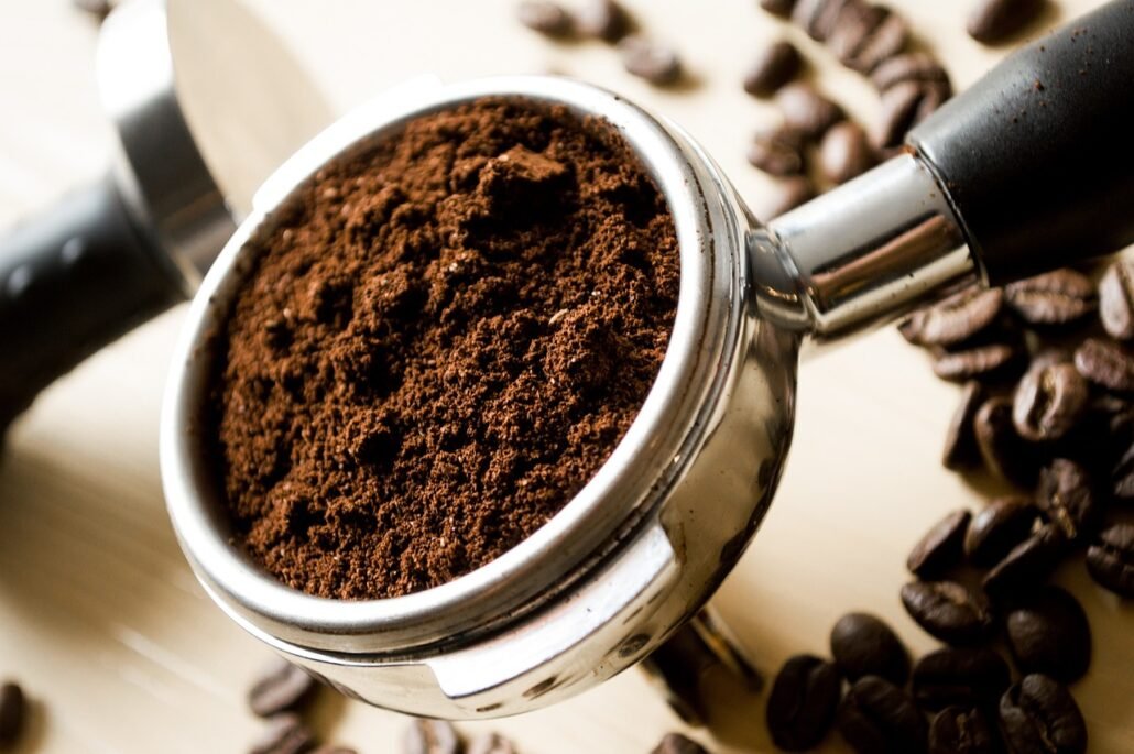 coffee grounds drying on kitchen paper under sunlight
