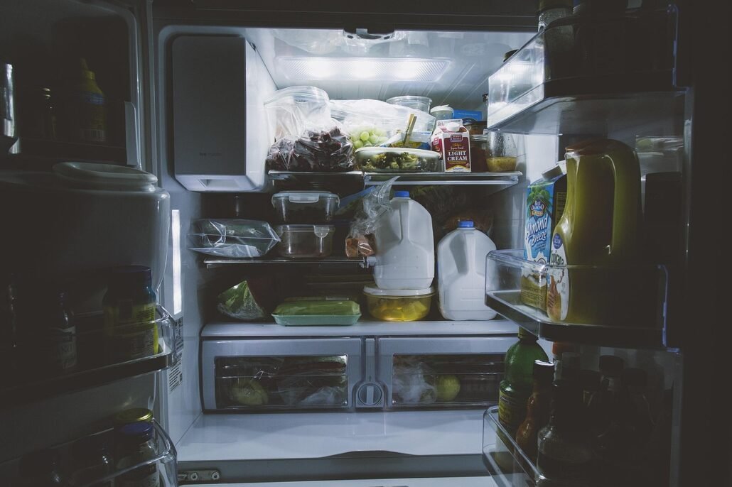 baking soda open container placed inside refrigerator shelf