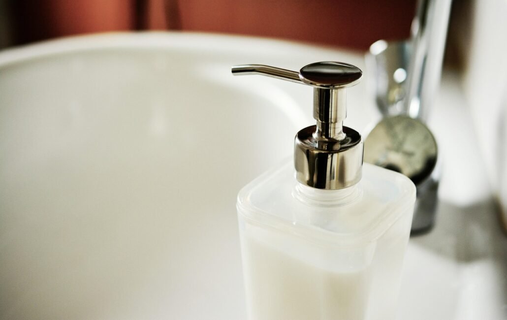 comparison of citric acid and bleach cleaning products on bathroom counter