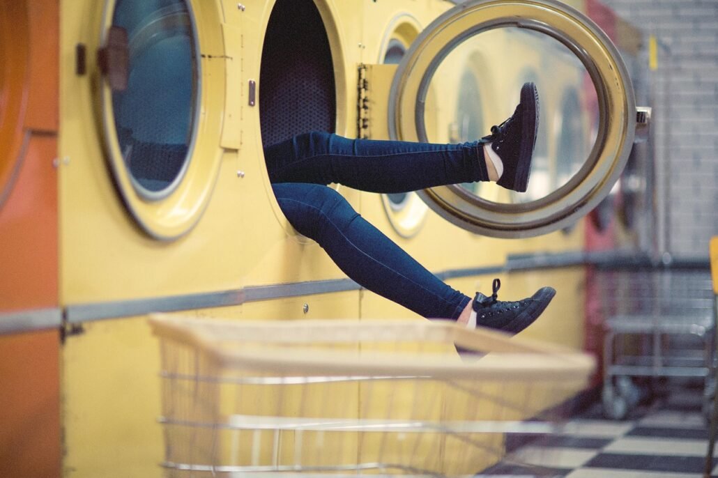 washing machine drum with bedding and laundry balls inside